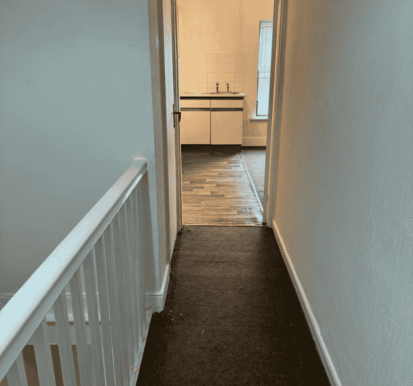 After Image- Peeling ceiling and damaged wall in hallway following wallpaper stripping, surface repair and painting.