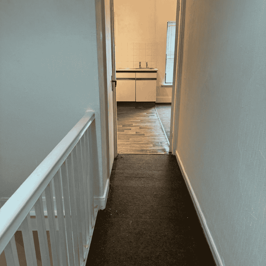 After Image- Peeling ceiling and damaged wall in hallway following wallpaper stripping, surface repair and painting.