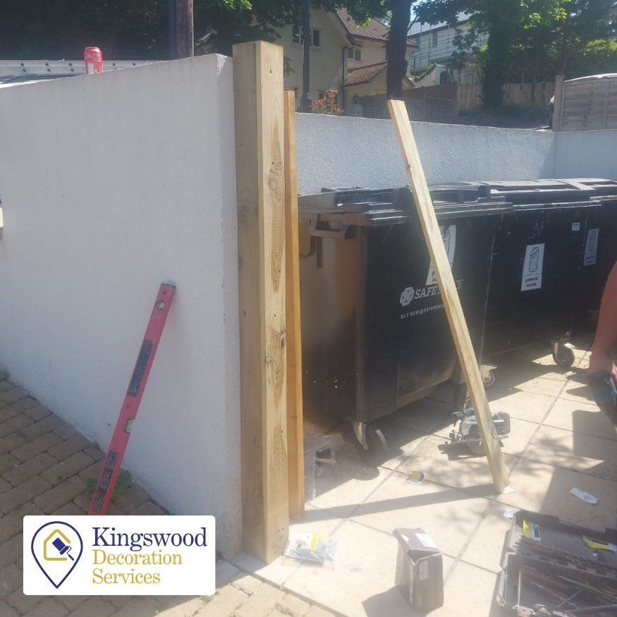 Northamptonshire Gate Fitting Project Before- The original site featured exposed bin areas with no existing gate, offering little privacy or security. Materials were being staged and the timber uprights were prepared for installation against the rendered wall.