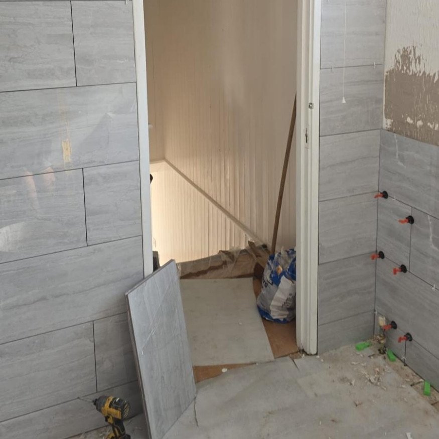 Image 5 (During)
Construction area showing staircase view, as walls and corners are tiled with clean-cut finish in progress.