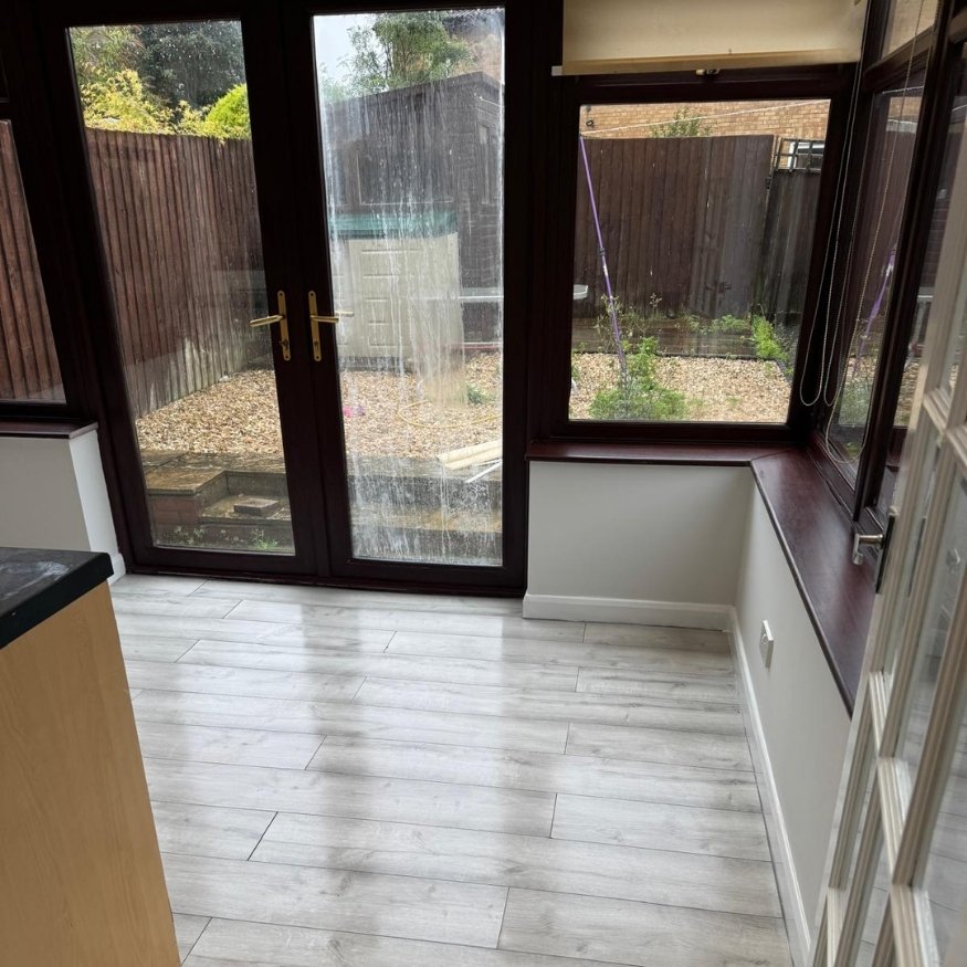 Conservatory area after the works, showing brighter floor tones, clean finishes, and surface restoration through our full property refurbishment in Wellingborough.