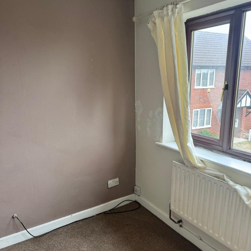 Living room walls showing signs of wear
The entrance area presented with marked walls, dated trim, and fading carpets ahead of the refurbishment.