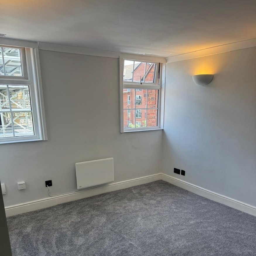Living area after the property renovation in Northamptonshire, featuring new carpet, fresh paint, and a bright, modern finish.