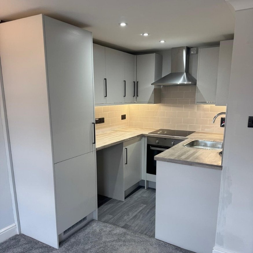 Brand-new kitchen installed with sleek cabinetry and improved layout for everyday functionality.